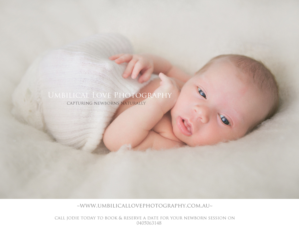 baby looking at the camera wrapped up