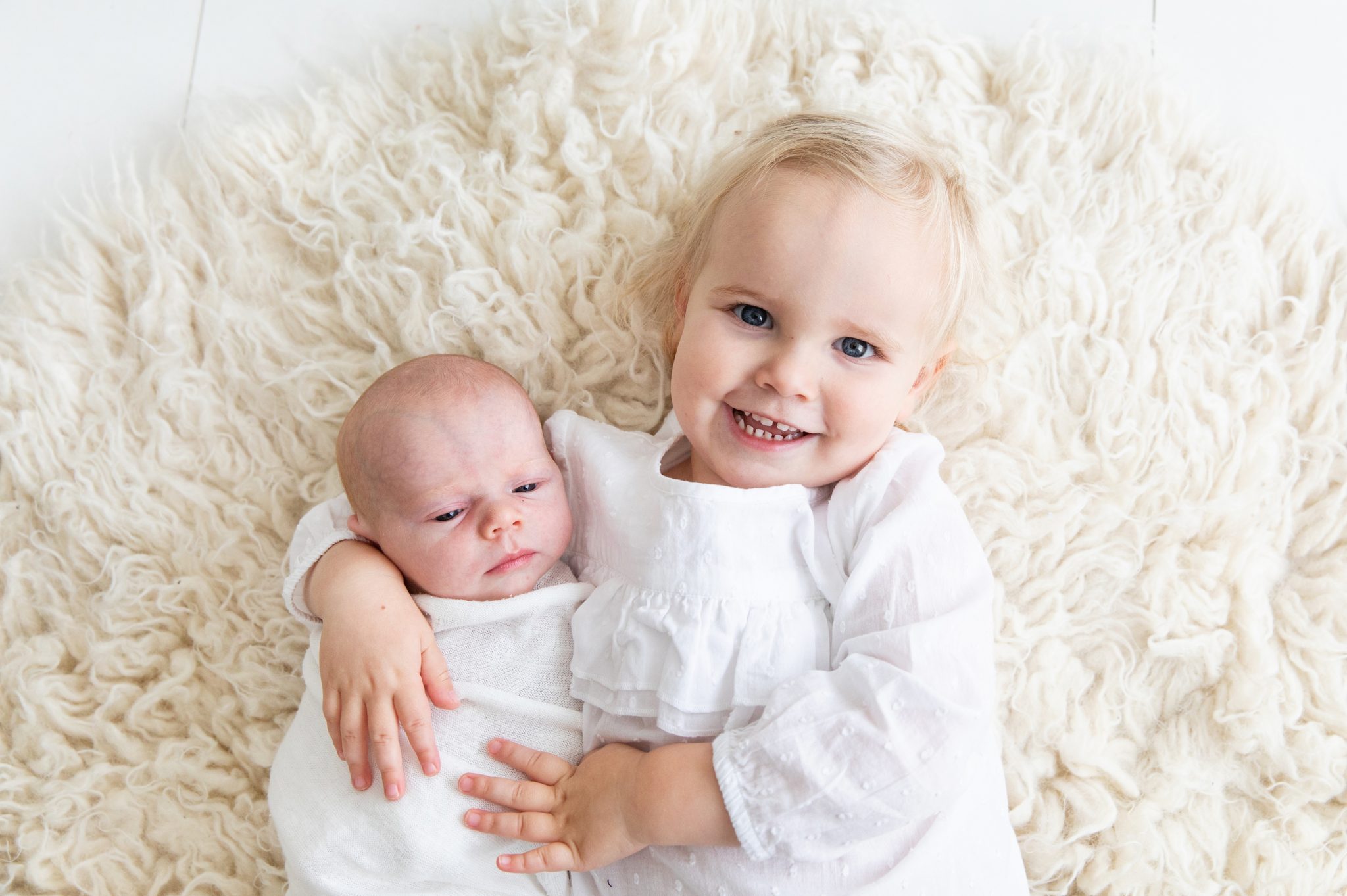 Big sister holds her new baby sister