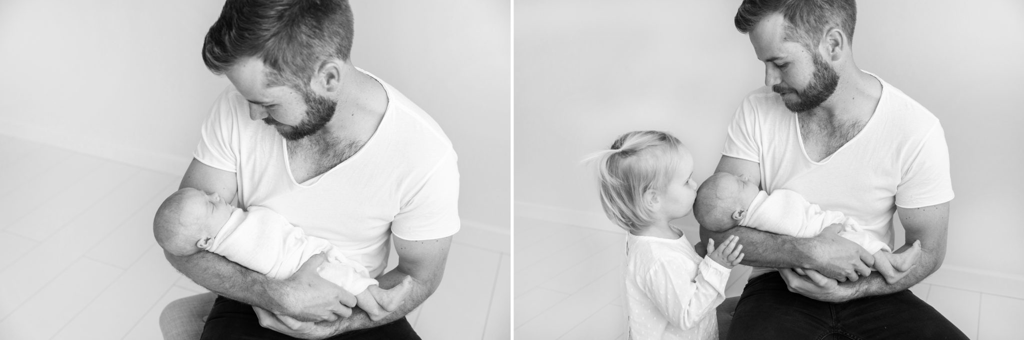 Dad holds his newborn baby girl